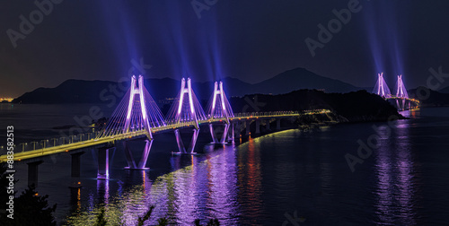 High angle night view of Geoga Bridge with pink lights on the sea near Geoje-si, South Korea
 photo