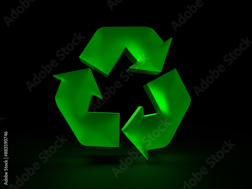 Green recycle symbol glowing on black background representing environmental awareness