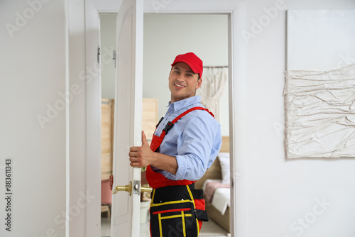 Male worker with door showi...