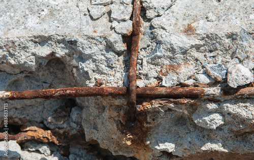 Reinforced concrete is broken and rusted.