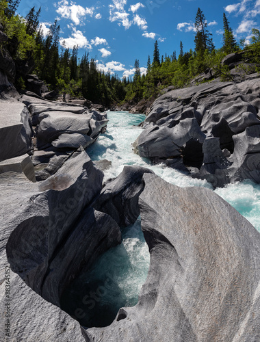 Marble rocks of Marmorslottet, Rana, Helgeland, Norge. Wild water stream in arctic Norway. Beautiful turquoise water flowing through a Norwegian mountain valley outside Svartisen national park