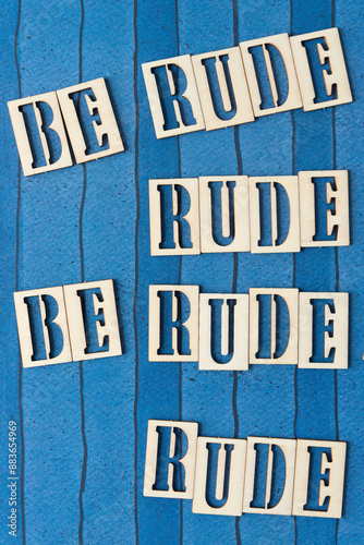 Photography paradoxical, but fun sign with wood letters and message: be rude, rude