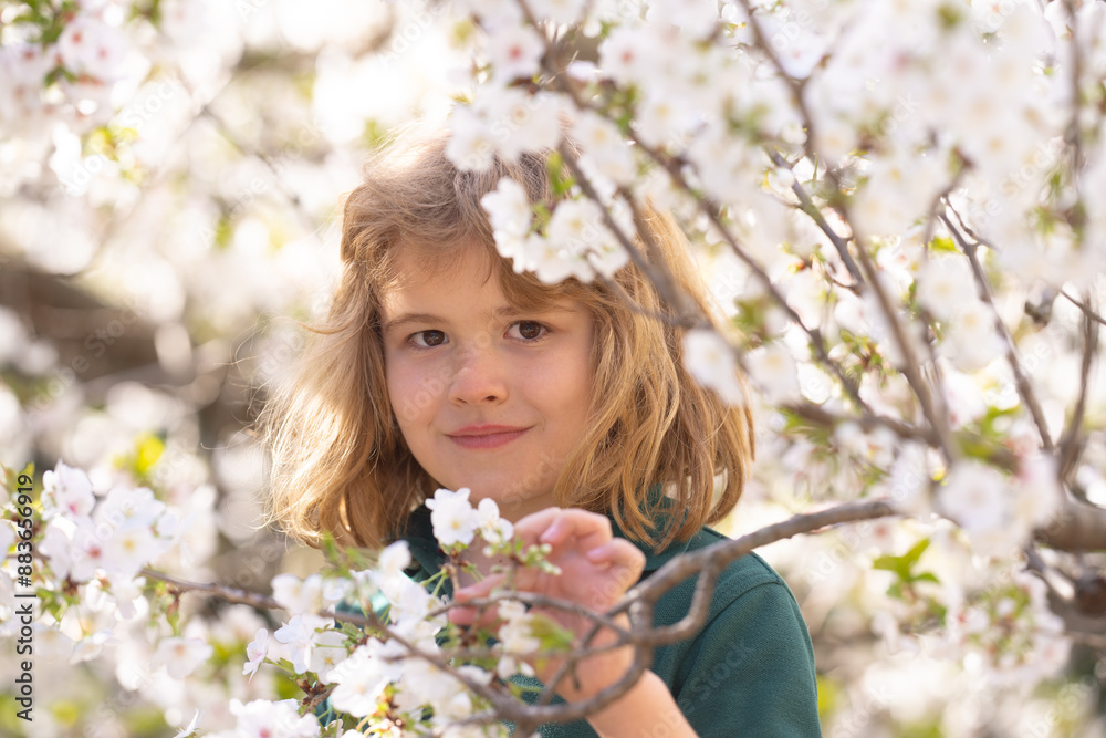 Cute blonde kid boy in spring garden. Little child under a blossom tree. Happy kid playing under blooming cherry tree. Kid with flower on Easter. Adorable kid in blooming cherry garden on spring day. Cute blonde kid boy in spring garden. Little child under a blossom tree. Happy kid playing under blooming cherry tree. Kid with flower on Easter. Adorable kid in blooming cherry garden on spring day.
