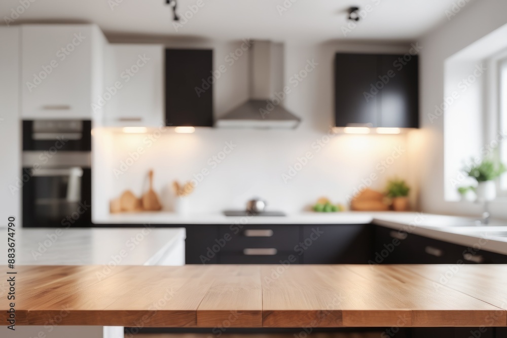 blurred pastel Sleek cabinets and stainless steel appliances define a modern kitchen interior with empty tabletop