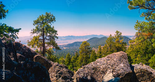 Scattergravel Mountain Rocky Hilltop View of Helena, Montana, USA: Tranquil beauty of the pine forest with lichen-covered glacial boulders and wildfire smoke