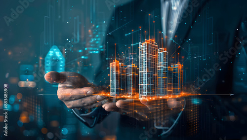 Businessman holding a virtual hologram of real estate buildings or a building model on a dark background, representing a technology and architecture concept. 