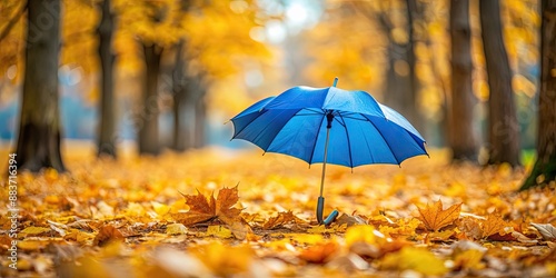 Vivid blue umbrella standing out among falling yellow leaves in warm autumnal setting, autumn, foliage, season, vibrant © Udomner