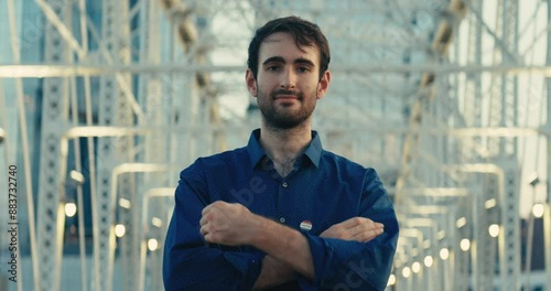 Young man smiling with an ‘I Voted’ sticker and pin 