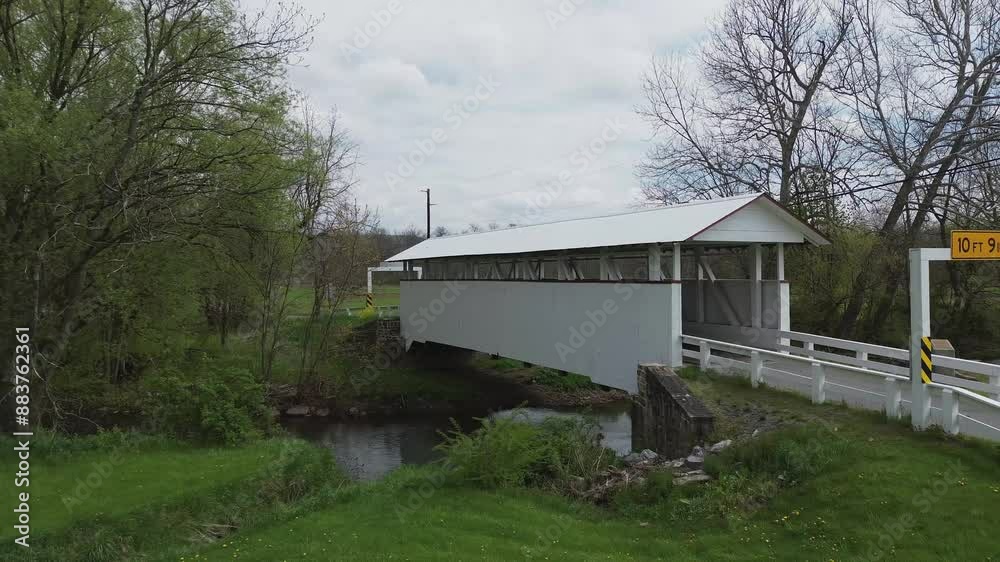 Snooks covered bridge near New Paris PA. Low level, rotating shot that highlights the open side and design of the bridge. Shot on an early Spring day. Snooks covered bridge near New Paris PA. Low level, rotating shot that highlights the open side and design of the bridge. Shot on an early Spring day.