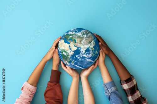 Fototapeta Naklejka Na Ścianę i Meble -  A group of people holding a globe in their hands