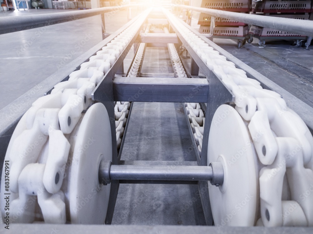 Fototapeta premium The conveyor of chick counter machine on industrial hatchery. Chain convenyor in industrial machinery.