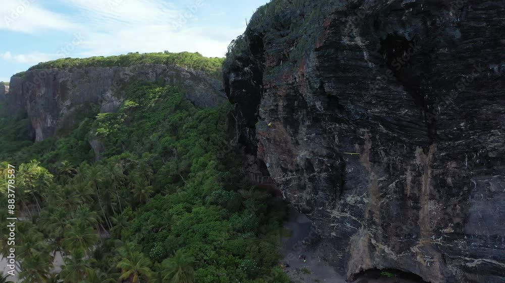 drone shoot of the climbing in rock wall in the tropical beach in the cabribbean drone shoot of the climbing in rock wall in the tropical beach in the cabribbean