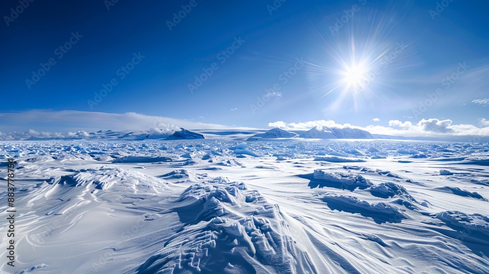 Fototapeta premium A large snow covered area with the sun shining.