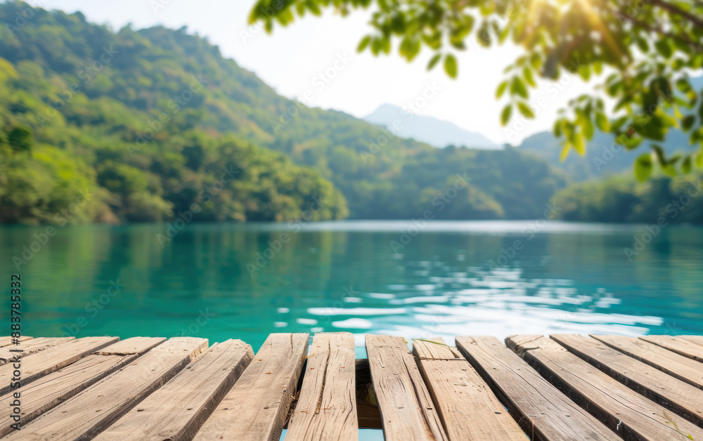 Scenic view of serene lake with wooden dock and lush green mountains in background, under bright, clear sky. Scenic view of serene lake with wooden dock and lush green mountains in background, under bright, clear sky.
