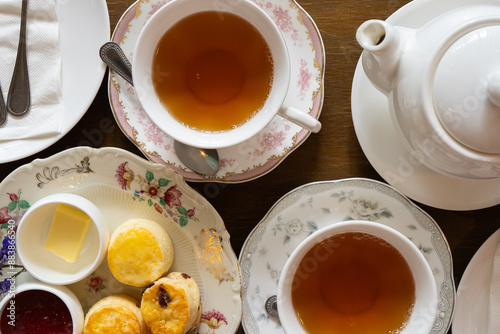 Close up of Scones Strawberry Jam and Butter Served with Hot Tea in Afterernoon
