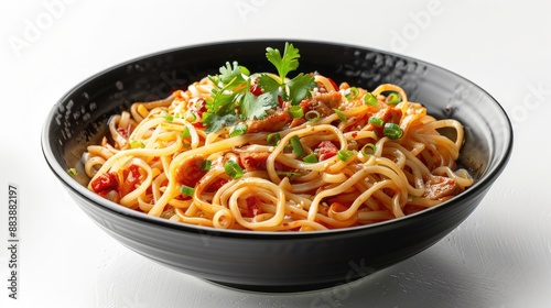 Noodles with accompaniments in a black bowl, looks delicious on a clean white background.