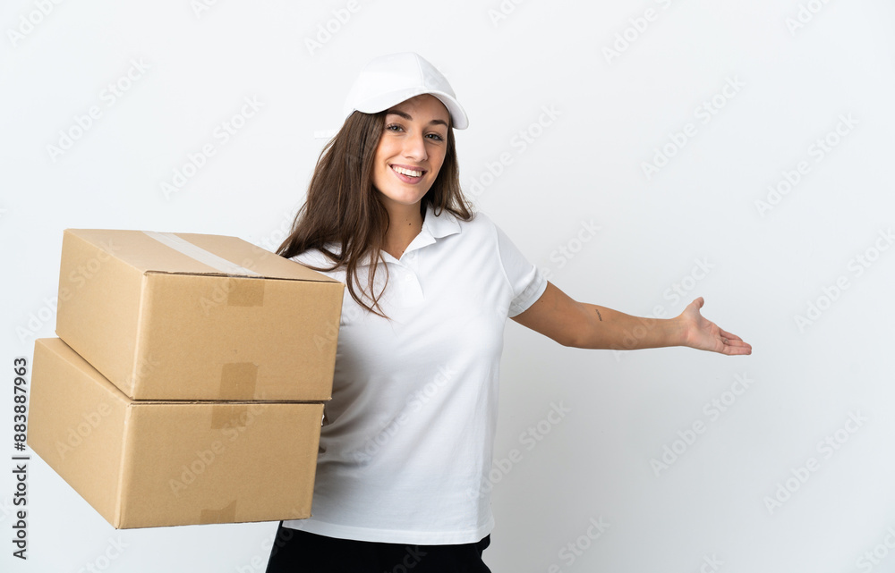 Young delivery woman over isolated white background extending hands to the side for inviting to come Young delivery woman over isolated white background extending hands to the side for inviting to come