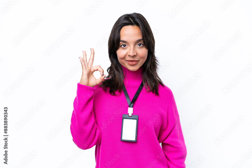 Young hispanic woman with ID card isolated on white background showing ok sign with fingers Young hispanic woman with ID card isolated on white background showing ok sign with fingers