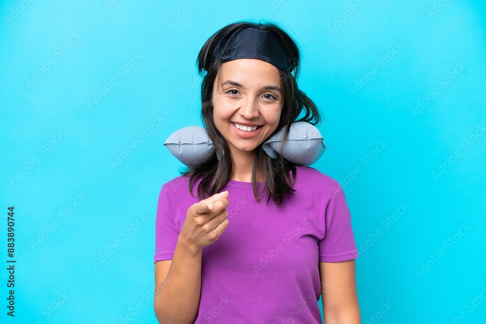 Young caucasian woman with Inflatable Travel Pillow isolated on blue background points finger at you with a confident expression Young caucasian woman with Inflatable Travel Pillow isolated on blue background points finger at you with a confident expression