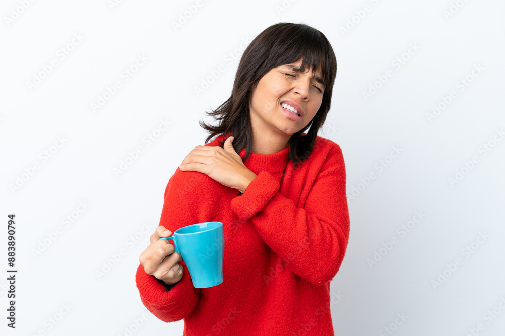 Young caucasian woman holding cup of coffee isolated on white background suffering from pain in shoulder for having made an effort Young caucasian woman holding cup of coffee isolated on white background suffering from pain in shoulder for having made an effort