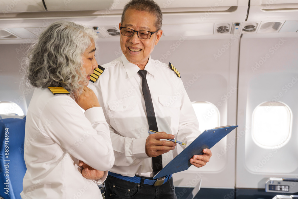 Obraz premium Mature male and female pilots meet inside an airplane, holding hands. Their gesture signifies teamwork, trust, and camaraderie in aviation, fostering a safe and collaborative work environment.