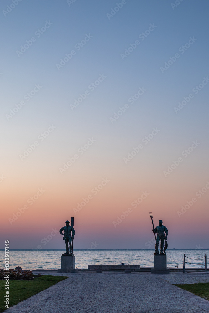 Sunrise on the shore and harbor of a lake in summer. Colorful sky with a wide view of the Horiont. Nature landscape at the marina of Balatonfüred Vitorláskikötő, Balaton, Lake Balaton, Siófok, Hungary