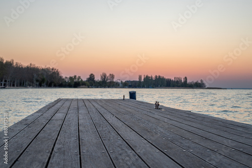 Sunrise on the shore and harbor of a lake in summer. Colorful sky with a wide view of the Horiont. Nature landscape at the marina of Balatonfüred Vitorláskikötő, Balaton, Lake Balaton, Siófok, Hungary photo