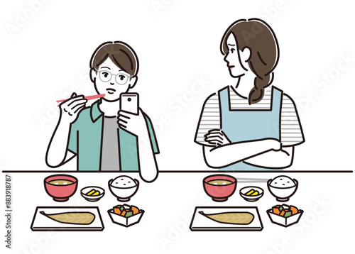 食事中にスマホを触る息子を訝しげに見る母親
