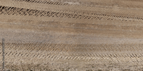 view from above on texture of wet gravel road with puddles after rain photo