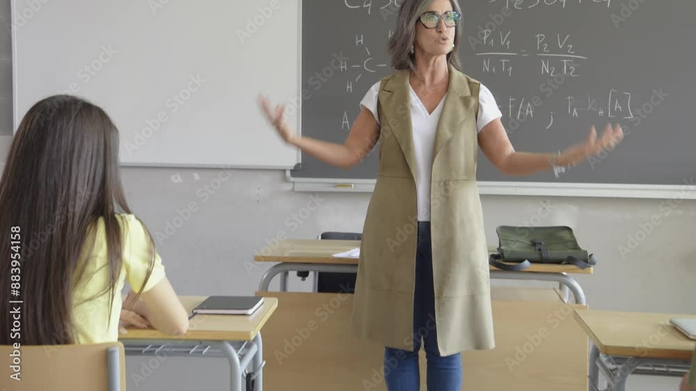 Woman teacher giving a science class explaining in a multiethnic class in a high school. Back to school. High school, education