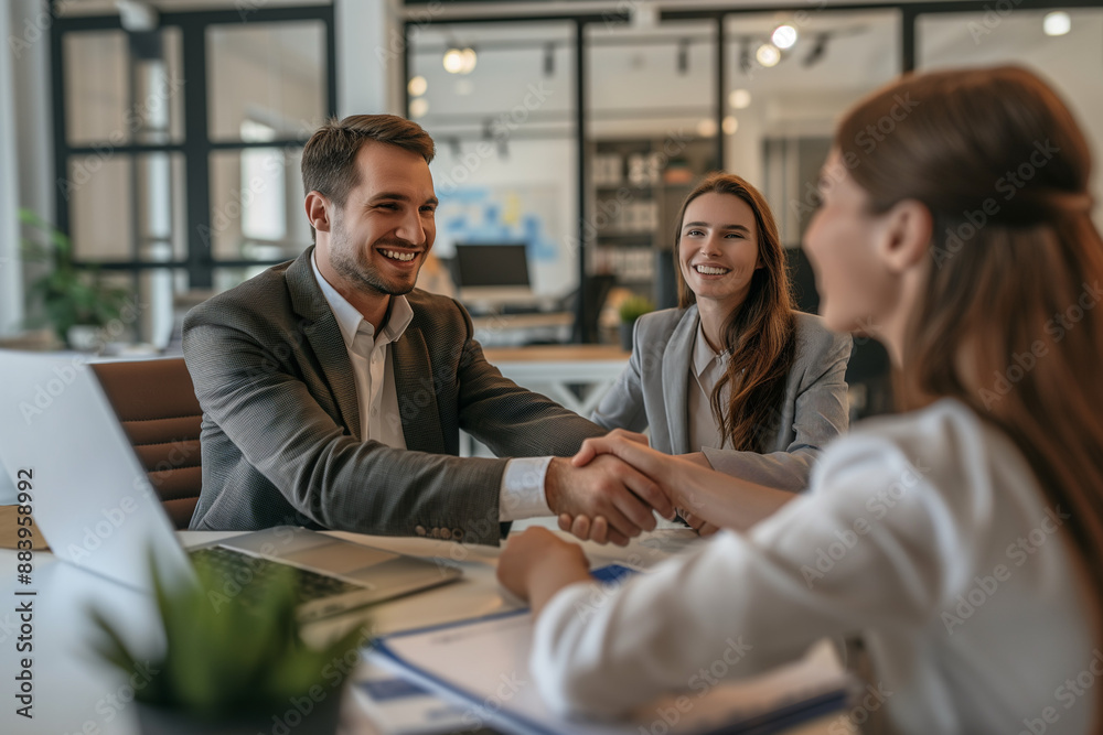 Fototapeta premium Business Meeting with Happy Mood, Three People Shaking Hands in Modern Office