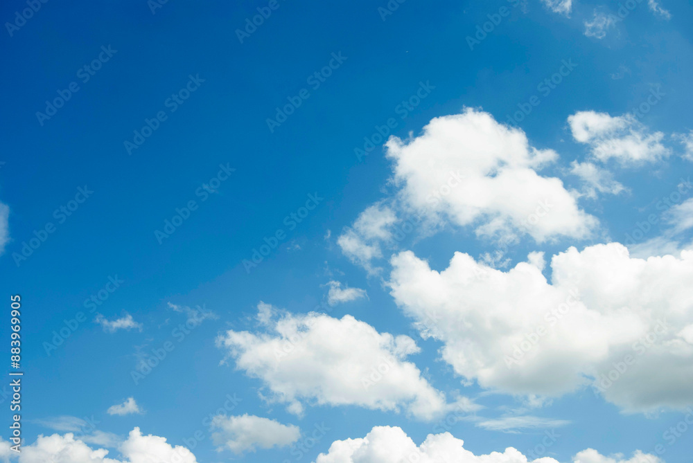 Fototapeta premium Blue sky background. Half clear half cloudy sky. Blue and white texture. sky and a cloud frame.