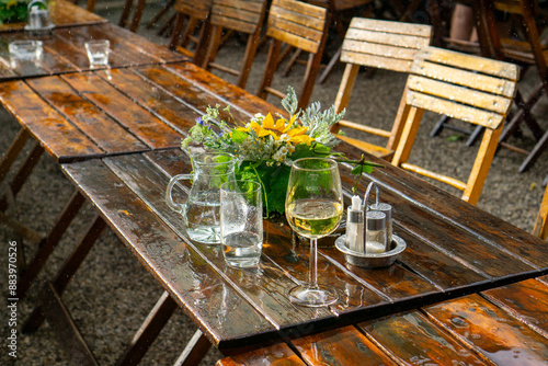 Wet table during a rain shower in summer at a heurigen (Austrian name) tavern in lower austria