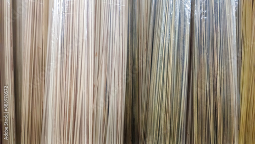 The Texture Of The Arrangement Of Broomsticks Wrapped In Clear Plastic