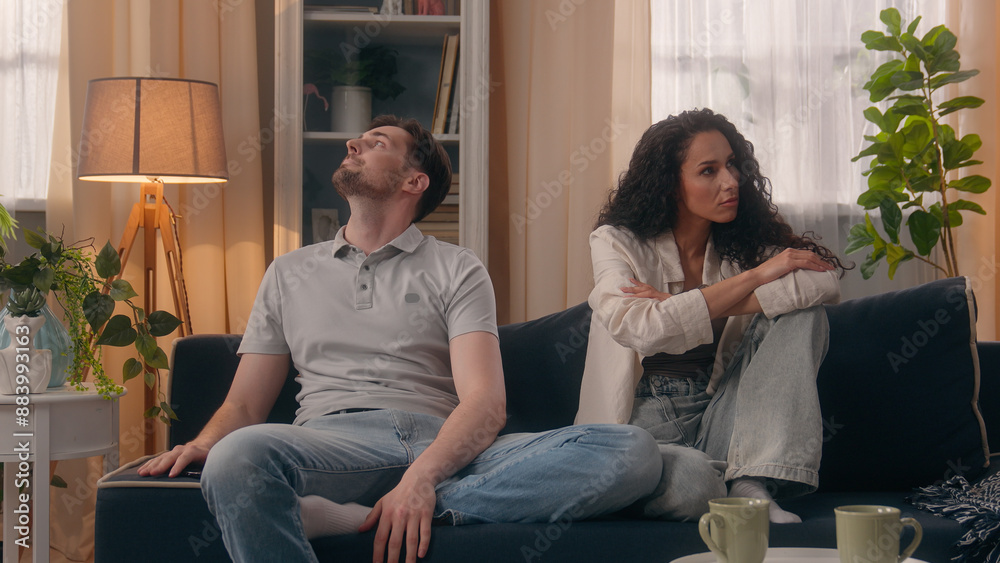 Obraz premium Multiracial upset angry offended couple family Caucasian man guy male boyfriend husband Hispanic woman girl female girlfriend wife ignoring after quarrel conflict divorce relationship problem at home