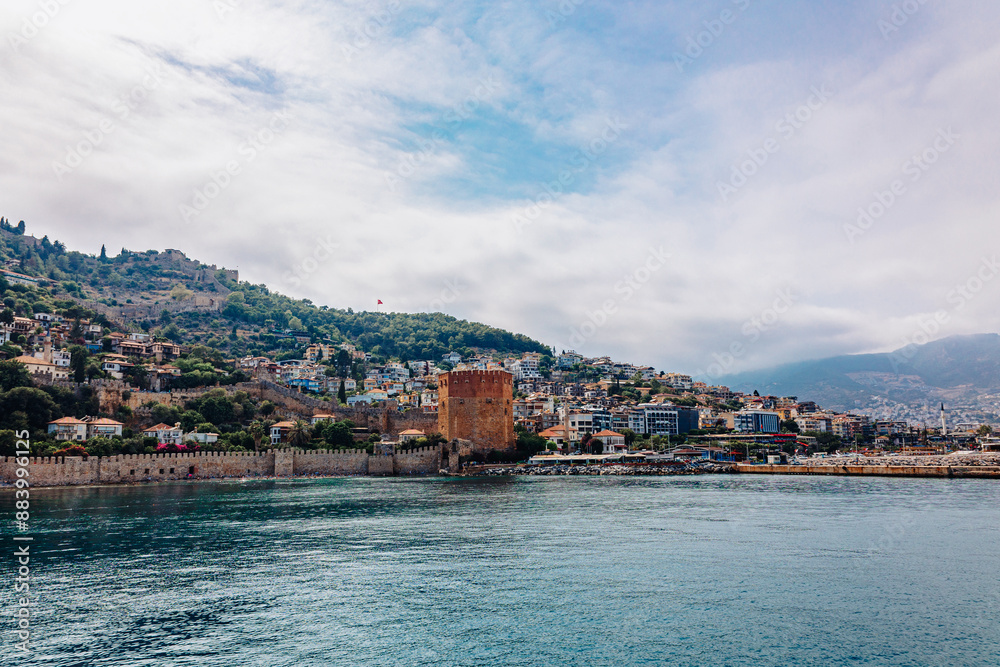 Landscape view old walls of fortress and Red tower on Mediterranean coast. View of Alanya Castle, stone ruins in harbor Alanya, Turkey. High quality photo