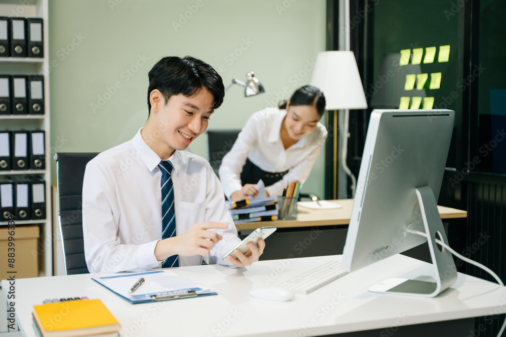 Young businessman working at office with laptop, tablet and taking notes on the paper.. Young businessman working at office with laptop, tablet and taking notes on the paper..