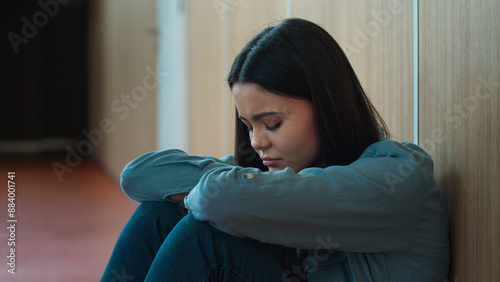 Free Download Caucasian sad upset worried stressed student girl female schoolgirl woman ill bad negative suffering pupil teenager teen in school university college corridor sitting on floor education study problem - GFXLoad