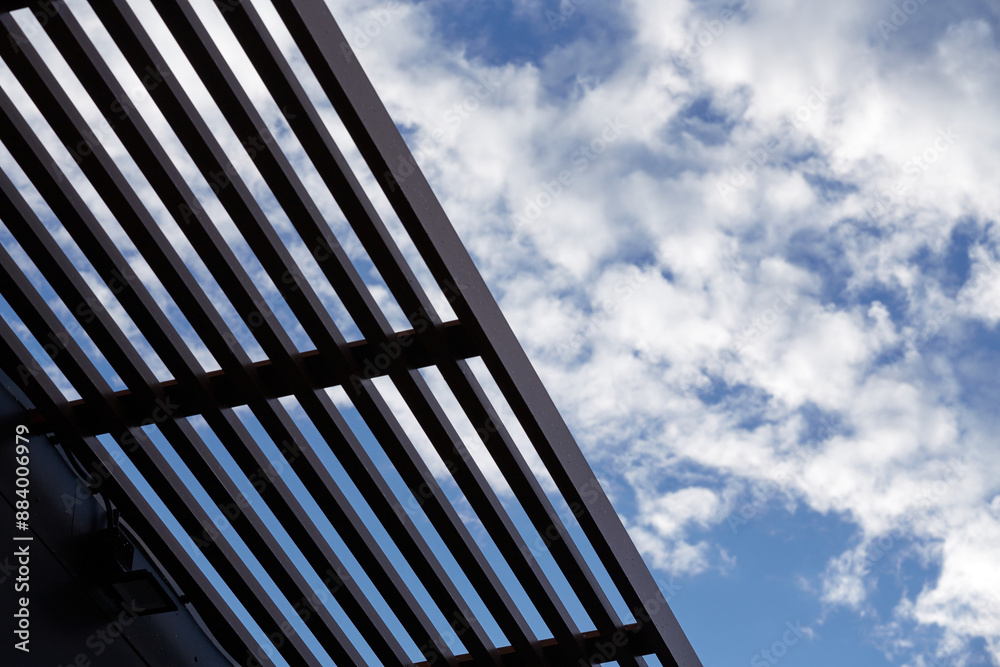 the view from below is a slatted roof and blue sky the view from below is a slatted roof and blue sky