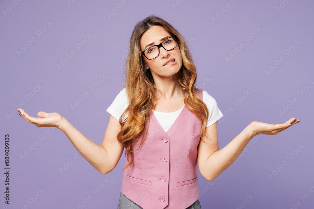 Young sad employee business woman corporate lawyer wear white t-shirt vest glasses spread hands shrugging shoulders look puzzled isolated on plain purple background studio. Achievement career concept. Young sad employee business woman corporate lawyer wear white t-shirt vest glasses spread hands shrugging shoulders look puzzled isolated on plain purple background studio. Achievement career concept.