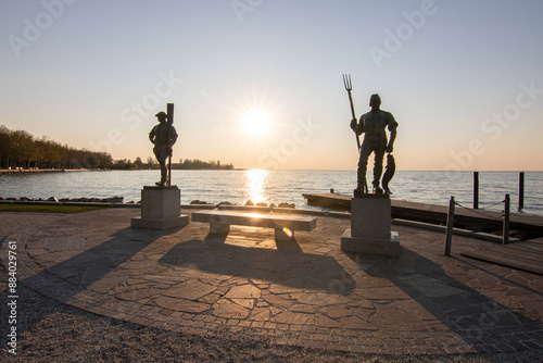 Sunrise on the shore and harbor of a lake in summer. Colorful sky with a wide view of the Horiont. Nature landscape at the marina of Balatonfüred Vitorláskikötő, Balaton, Lake Balaton, Siófok, Hungary photo