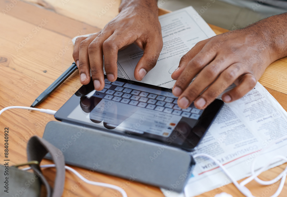 Man, hands and tablet for job search on table, newspaper and app for communication in home. Male person, information and unemployed guy for browsing career site, social media and keyboard for email Man, hands and tablet for job search on table, newspaper and app for communication in home. Male person, information and unemployed guy for browsing career site, social media and keyboard for email