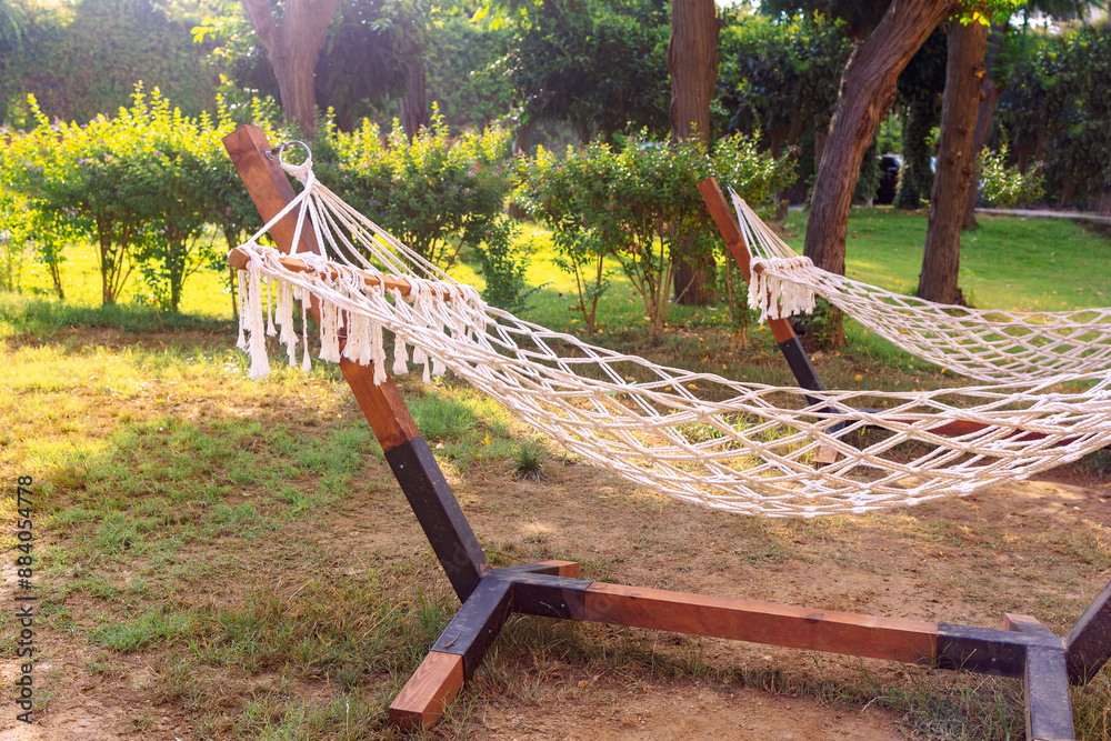 Wicker hanging hammock at green garden for relaxation. High quality photo Wicker hanging hammock at green garden for relaxation. High quality photo