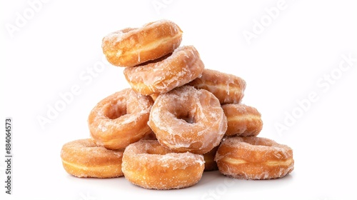 Obraz na płótnie A stack of cinnamon donuts coated in sugar glaze on a white background.