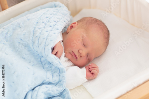 Newborn baby boy in hospital cot © famveldman