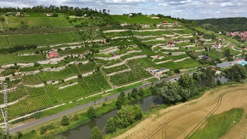 Flight along vineyards near Freyburg. River Unstrut in the foreground. Northernmost wine-growing region in Europe. Mineral-rich red sandstone, shell limestone and loess clay soils. Travel destination.