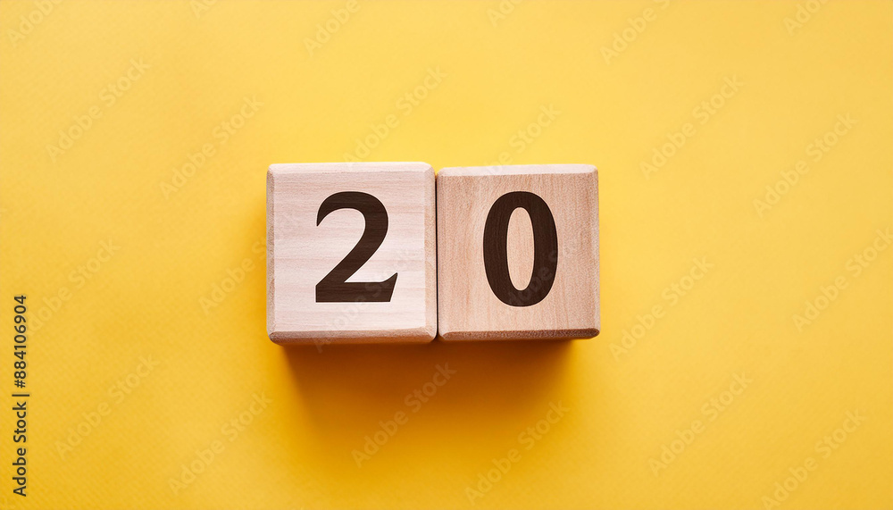 Wooden cubes with number 20 on isolated yellow backdrop. Wood blocks. Close-up. Flat lay Wooden cubes with number 20 on isolated yellow backdrop. Wood blocks. Close-up. Flat lay