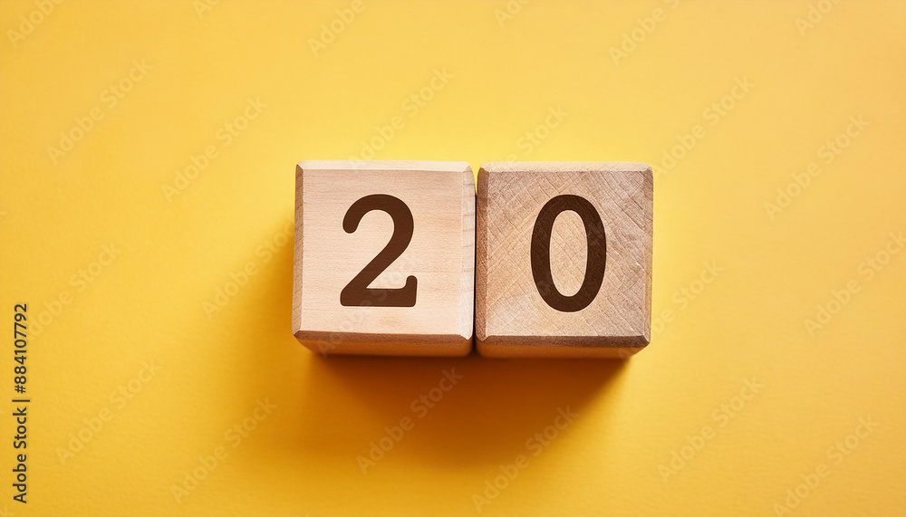 Wooden cubes with number 20 on isolated yellow backdrop. Wood blocks. Close-up. Flat lay Wooden cubes with number 20 on isolated yellow backdrop. Wood blocks. Close-up. Flat lay