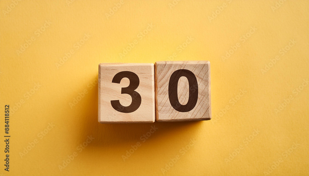 Wooden cubes with number 30 on isolated yellow backdrop. Wood blocks. Close-up. Flat lay Wooden cubes with number 30 on isolated yellow backdrop. Wood blocks. Close-up. Flat lay