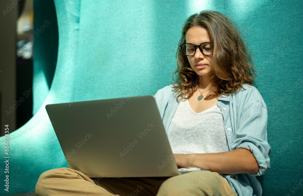 Young Caucasian pretty woman freelancer in glasses using laptop for online work Young Caucasian pretty woman freelancer in glasses using laptop for online work